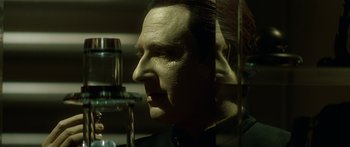 Movie still from “Star Trek: Generations” (1994), directed by David Carson – A person in a glass display case; Close Up shot, Over the shoulder angle