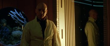 Movie still from “Star Trek: Generations” (1994), directed by David Carson – A bald man standing in front of a building; Close Up shot, Low angle