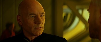 Movie still from “Star Trek: Generations” (1994), directed by David Carson – An older man with a bald head looking into the distance; Close Up shot, Over the shoulder angle