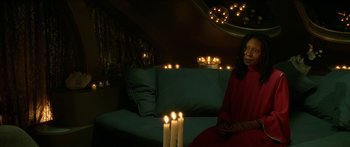 Movie still from “Star Trek: Generations” (1994), directed by David Carson – A woman sitting in front of a group of lit candles; Medium shot, High angle