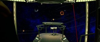 Movie still from “Star Trek: Generations” (1994), directed by David Carson – A computer desk in a room with a space background; Extreme Wide shot, High angle