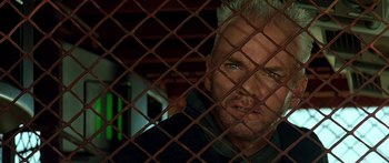 Movie still from “Star Trek: Generations” (1994), directed by David Carson – A person behind a metal fence; Close Up shot, Low angle