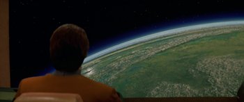 Movie still from “Star Trek: Generations” (1994), directed by David Carson – A person looking out at the earth at night; Extreme Wide shot, High angle