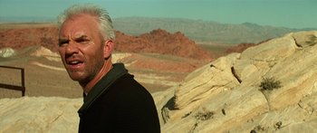 Movie still from “Star Trek: Generations” (1994), directed by David Carson – An older man standing on top of a mountain; Close Up shot, Low angle