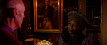 Movie still from “Star Trek: Generations” (1994), directed by David Carson – A woman in front of a portrait of a man; Close Up shot, Over the shoulder angle