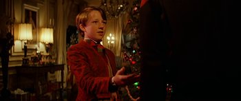 Movie still from “Star Trek: Generations” (1994), directed by David Carson – A young boy in a red jacket standing next to a christmas tree; Medium shot, Over the shoulder angle