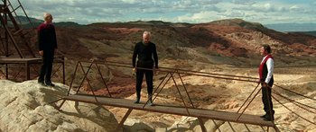 Movie still from “Star Trek: Generations” (1994), directed by David Carson – A man standing on top of a metal bridge; Wide shot, Low angle