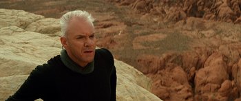 Movie still from “Star Trek: Generations” (1994), directed by David Carson – A man in a black shirt is on a cliff; Close Up shot, Over the shoulder angle