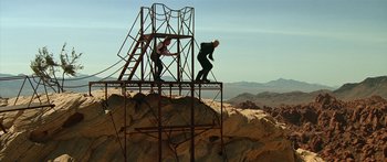 Movie still from “Star Trek: Generations” (1994), directed by David Carson – Two men standing on a metal structure on top of a hill; Extreme Wide shot, Low angle