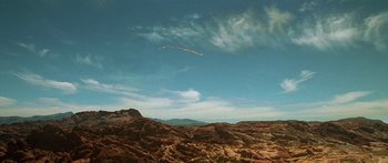Movie still from “Star Trek: Generations” (1994), directed by David Carson – A kite flying high in the sky over a rocky area; Extreme Wide shot, Low angle