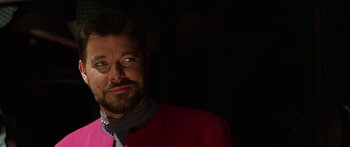 Movie still from “Star Trek: Generations” (1994), directed by David Carson – A person with a beard wearing a pink jacket; Close Up shot, Over the shoulder angle