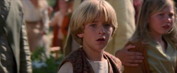 Movie still from “Star Trek: Insurrection” (1998), directed by Jonathan Frakes – A young boy with blonde hair and blue eyes looking at the camera; Close Up shot, Over the shoulder angle