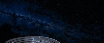 Movie still from “Star Trek: Insurrection” (1998), directed by Jonathan Frakes – A view of the sky at night from the bottom of a space ship; Extreme Wide shot, Overhead angle
