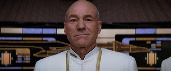 Movie still from “Star Trek: Insurrection” (1998), directed by Jonathan Frakes – An older man with a bald head wearing a white shirt; Close Up shot, Low angle