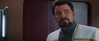 Movie still from “Star Trek: Insurrection” (1998), directed by Jonathan Frakes – A man with a beard looking up; Close Up shot, Over the shoulder angle