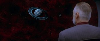 Movie still from “Star Trek: Insurrection” (1998), directed by Jonathan Frakes – An image of an outer space scene with planets; Extreme Wide shot, Over the shoulder angle