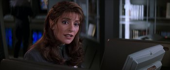 Movie still from “Star Trek: Insurrection” (1998), directed by Jonathan Frakes – A person sitting in front of a computer; Close Up shot, Over the shoulder angle