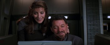 Movie still from “Star Trek: Insurrection” (1998), directed by Jonathan Frakes – A man and a woman looking at a computer screen; Close Up shot, Over the shoulder angle