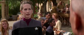 Movie still from “Star Trek: Insurrection” (1998), directed by Jonathan Frakes – A group of people standing around a table; Close Up shot, Over the shoulder angle