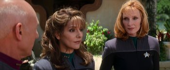 Movie still from “Star Trek: Insurrection” (1998), directed by Jonathan Frakes – A woman in a star trek uniform looking at the camera; Close Up shot, Over the shoulder angle