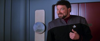 Movie still from “Star Trek: Insurrection” (1998), directed by Jonathan Frakes – A person with a beard wearing a uniform; Close Up shot, Over the shoulder angle
