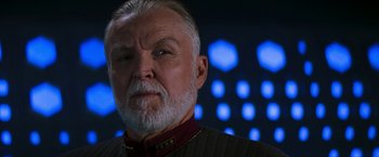 Movie still from “Star Trek: Insurrection” (1998), directed by Jonathan Frakes – An older man with a beard and a mustache; Close Up shot, Over the shoulder angle