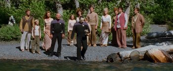 Movie still from “Star Trek: Insurrection” (1998), directed by Jonathan Frakes – A group of people standing next to a body of water; Wide shot, High angle