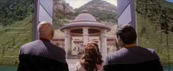 Movie still from “Star Trek: Insurrection” (1998), directed by Jonathan Frakes – A group of people standing in front of a gazebo; Wide shot, Over the shoulder angle