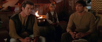 Movie still from “Star Trek: Insurrection” (1998), directed by Jonathan Frakes – A group of people sitting in front of a fire; Medium shot, Over the shoulder angle