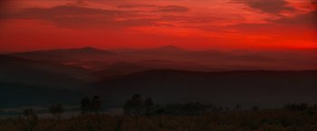 Movie still from “Star Trek: Insurrection” (1998), directed by Jonathan Frakes – A view of a red sky at dusk with mountains in the background; Extreme Wide shot, Low angle