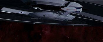 Movie still from “Star Trek: Insurrection” (1998), directed by Jonathan Frakes – A space ship is seen from below in the sky; Extreme Wide shot, Overhead angle