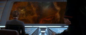 Movie still from “Star Trek: Insurrection” (1998), directed by Jonathan Frakes – A view from a moving escalator looking at a painting; Extreme Wide shot, Overhead angle