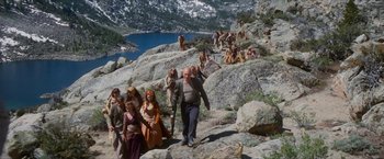 Movie still from “Star Trek: Insurrection” (1998), directed by Jonathan Frakes – A group of people on a rocky hill with mountains in the background; Wide shot, High angle