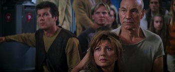 Movie still from “Star Trek: Insurrection” (1998), directed by Jonathan Frakes – A group of people sitting in front of each other; Close Up shot, Over the shoulder angle