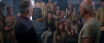 Movie still from “Star Trek: Insurrection” (1998), directed by Jonathan Frakes – A group of people sitting in a room; Medium shot, High angle