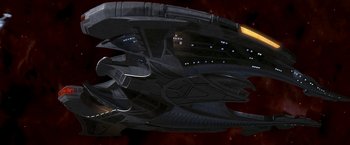 Movie still from “Star Trek: Insurrection” (1998), directed by Jonathan Frakes – An image of a space ship in the dark; Extreme Wide shot, Low angle