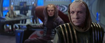 Movie still from “Star Trek: Insurrection” (1998), directed by Jonathan Frakes – Two klingons are sitting in a room together; Medium shot, Over the shoulder angle