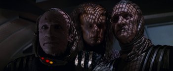 Movie still from “Star Trek: Insurrection” (1998), directed by Jonathan Frakes – A group of people in costumes are posing for a picture; Medium shot, Low angle