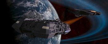 Movie still from “Star Trek: Insurrection” (1998), directed by Jonathan Frakes – An image of a space ship in front of the earth; Extreme Wide shot, Low angle