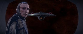 Movie still from “Star Trek: Insurrection” (1998), directed by Jonathan Frakes – An image of a man and a space ship in the background; Close Up shot, Over the shoulder angle