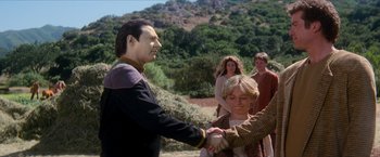 Movie still from “Star Trek: Insurrection” (1998), directed by Jonathan Frakes – A man and a woman shake hands in front of a group of people; Medium shot, Over the shoulder angle