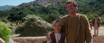 Movie still from “Star Trek: Insurrection” (1998), directed by Jonathan Frakes – A man and a young boy standing next to each other; Medium shot, Over the shoulder angle