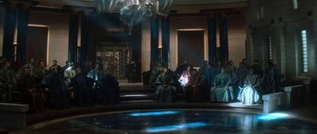 Movie still from “Star Trek: Nemesis” (2002), directed by Stuart Baird – A group of people sitting in a room with lights; Extreme Wide shot, Over the shoulder angle