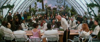 Movie still from “Star Trek: Nemesis” (2002), directed by Stuart Baird – A group of people sitting around a table with plates of food on top of it; Wide shot, Over the shoulder angle