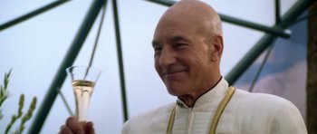 Movie still from “Star Trek: Nemesis” (2002), directed by Stuart Baird – An older man in a white shirt holding a glass of wine; Close Up shot, Low angle
