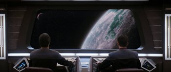 Movie still from “Star Trek: Nemesis” (2002), directed by Stuart Baird – Two men are sitting in front of a large screen; Extreme Wide shot, Over the shoulder angle