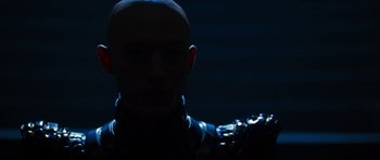 Movie still from “Star Trek: Nemesis” (2002), directed by Stuart Baird – A man in a black jacket is in the dark; Close Up shot, Low angle