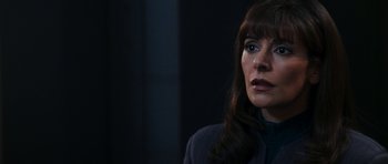 Movie still from “Star Trek: Nemesis” (2002), directed by Stuart Baird – A person with long dark hair; Close Up shot, Over the shoulder angle