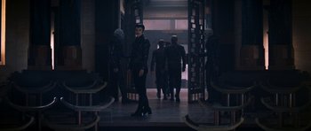 Movie still from “Star Trek: Nemesis” (2002), directed by Stuart Baird – A group of people standing in front of a building; Wide shot, Over the shoulder angle