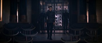 Movie still from “Star Trek: Nemesis” (2002), directed by Stuart Baird – A group of people standing in front of a door; Wide shot, Over the shoulder angle